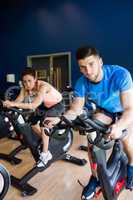 Man and woman using cycling exercise bikes