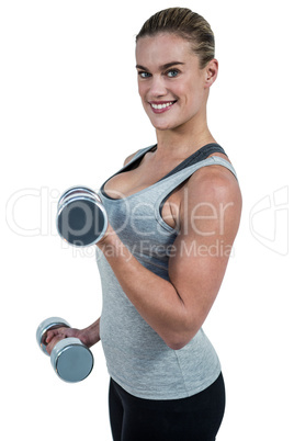 Muscular woman working out with dumbbells