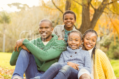 Portrait of a young family sitting in leaves