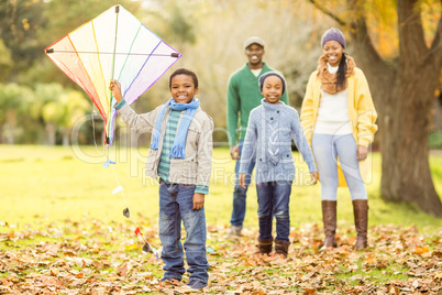 Young family playing with a kite