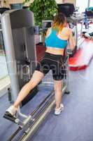 Woman on a weights machine for her legs