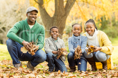 Portrait of young family holding leaves