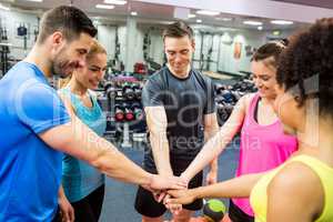 Fit people putting their hands together