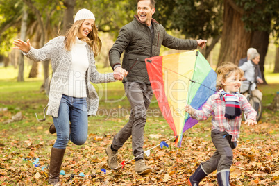 Young family playing with a kite