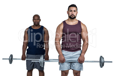 Man lifting barbell with trainer