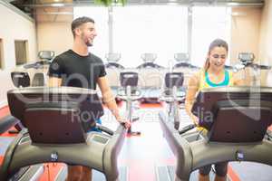 Man and woman using treadmills