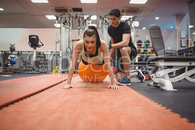 Fit woman working out with trainer