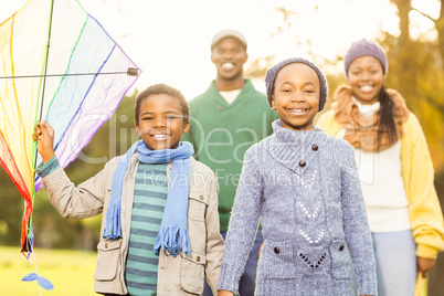 Young family playing with a kite