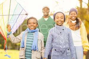 Young family playing with a kite