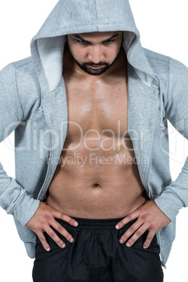 Muscular man in hooded jumper