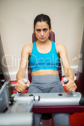 Woman using weights machine