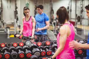 Fit couple working out in weights room