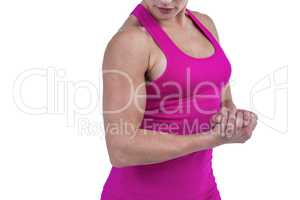 MId section of muscular woman flexing muscle