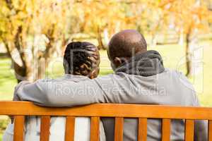 Happy senior couple discussing together on a bench