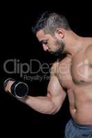 Muscular man lifting a dumbbell