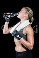 Muscular woman drinking water