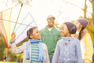 Young family playing with a kite