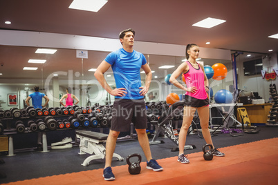 Fit couple working out in weights room