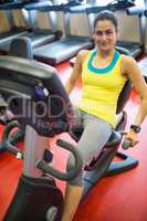 Smiling woman using exercise machine
