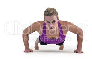 Muscular woman doing push ups