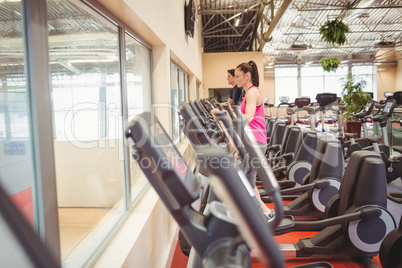 Fit people working out using machines