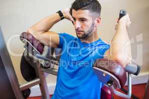 Concentrating man using weights machine