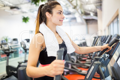 Smiling woman on the cross trainer