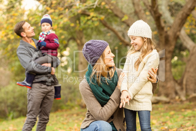 Smiling woman with her daughter against her husband and her son