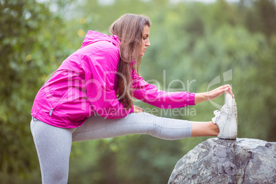 Fit woman stretching her leg