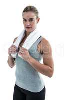 Muscular woman holding a towel around her neck