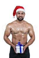 Muscular man in santa hat