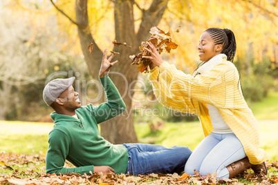 View of a young smiling couple in leaves