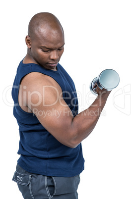 Muscular man exercising with dumbbell