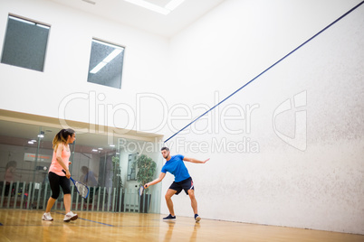 Couple playing a game of squash