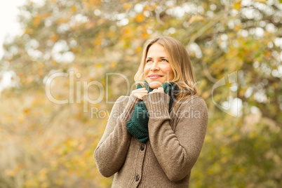 Smiling woman holding her scarf