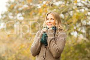 Smiling woman holding her scarf