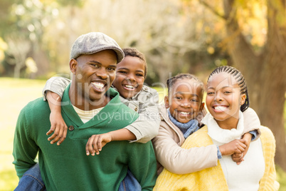 Portrait of a young smiling family in piggyback