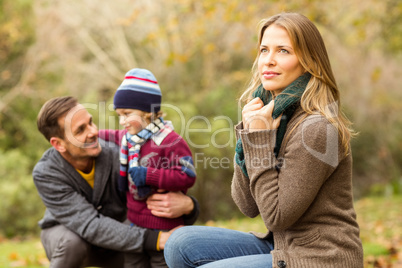 Smiling young couple with little boy posing