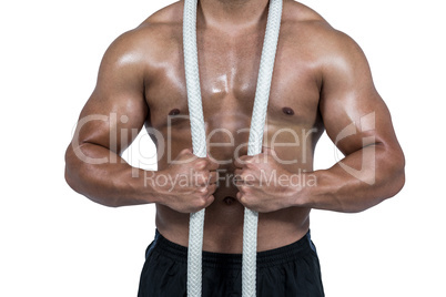 Muscular man with battle rope