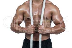 Muscular man with battle rope