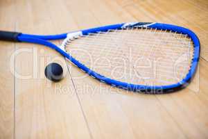 Close up of a squash racket and ball