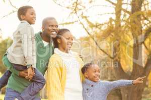 Portrait of a young smiling family pointing something
