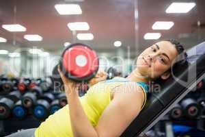 Smiling woman doing a workout with dumbbells