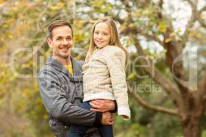 Happy father and his daughter posing in park