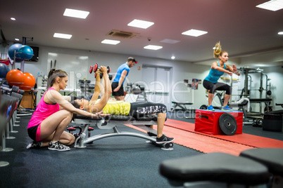 Fit people working out in weights room