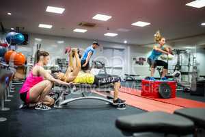 Fit people working out in weights room