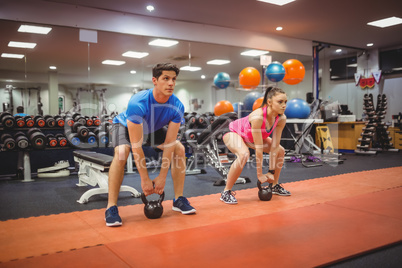 Fit couple working out in weights room