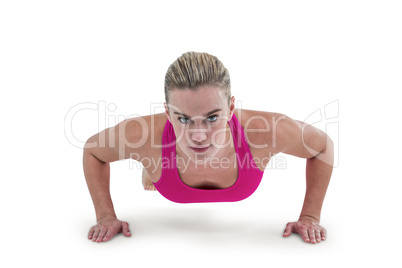 Portrait of pretty woman doing push ups