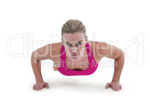 Portrait of pretty woman doing push ups