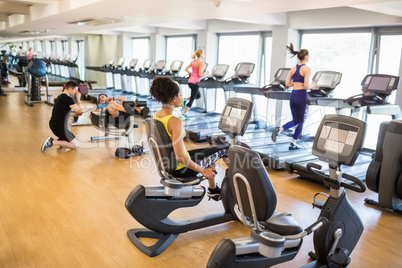 Fit people working out using machines